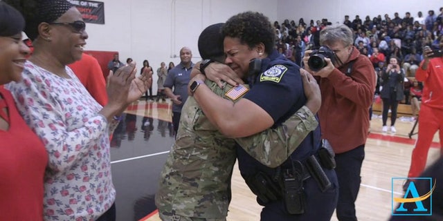 In a heartwarming video that has since gone viral, Aquil jogged out from behind the basketball players and cheerleaders in his fatigues, to embrace his emotional mom with a bear hug.