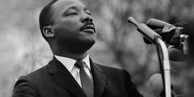 Dr. Martin Luther King, Jr. speaks before crowd of 25,000 civil rights marchers in front of the state Capitol in Montgomery, Alabama, on March 25, 1965.