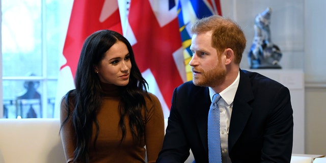 Britain's Prince Harry and Meghan, Duchess of Sussex gesture during their visit to Canada House in thanks for the warm Canadian hospitality and support they received during their recent stay in Canada, in London, Tuesday, Jan. 7, 2020. 
