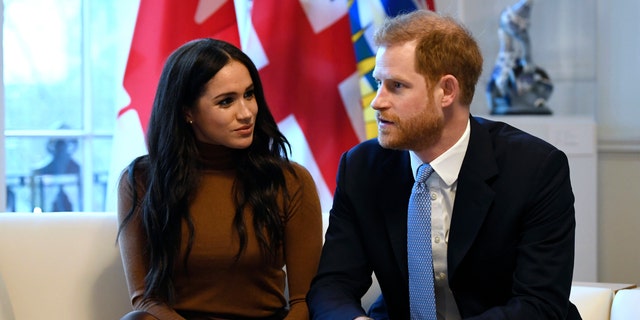 Britain's Prince Harry and Meghan, Duchess of Sussex gesture during their visit to Canada House in thanks for the warm Canadian hospitality and support they received during their recent stay in Canada, in London, Tuesday, Jan. 7, 2020. 