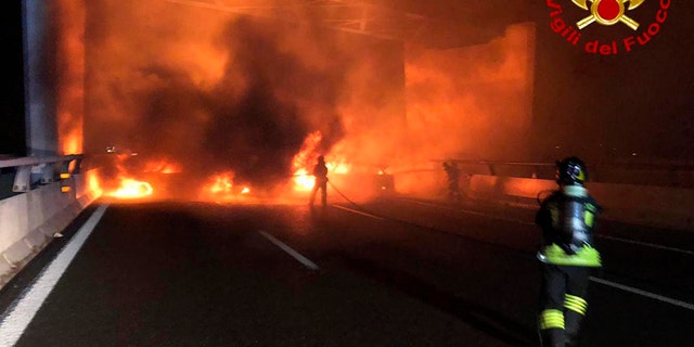 In a bid to rob an armored vehicle, a gang of thieves set up barriers of burning vehicles and spilled nails on a highway near Milan but were foiled when the driver evaded their traps. (AP/Italian Firefighters)