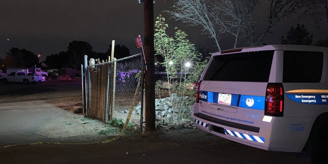 Police vehicle at home where a mother was charged with killing her three young children--a 7-month-old girl, a 2-year-old girl and a 3-year-old boy--after the children were found unresponsive by police Monday night.