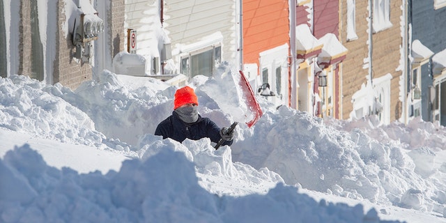 A resident digs out his walkway in St. John's Newfoundland on Saturday, Jan. 18, 2020. Andrew Vaughan/The Canadian Press via AP)