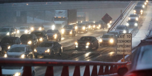 Heavy traffic is seen on Eisenhower Expressway in Chicago, Friday, Jan. 17, 2020. Hundreds of flights were canceled as a winter storm hits the city during evening commute Friday, creating a sloppy rush hour. (AP Photo/Nam Y. Huh)