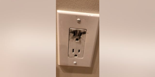 A scorch mark is seen on an electrical outlet after an 