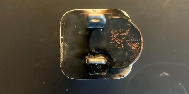 A penny and a phone-charger plug are fused together after a recent 