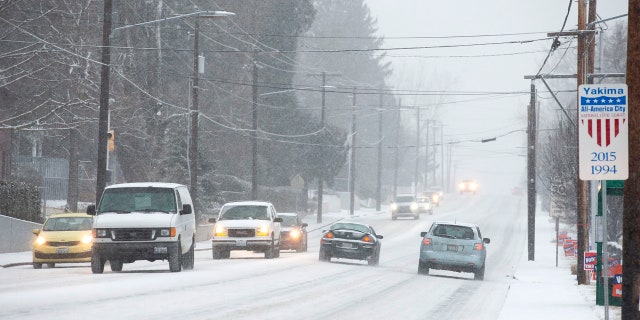 Vehicles travel through the snow on Tieton Drive on Wednesday, Jan. 15, 2020, in Yakima, Wash.