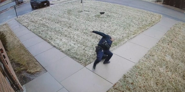 A police officer can be seen slipping and falling on black ice over the weekend in Wisconsin.