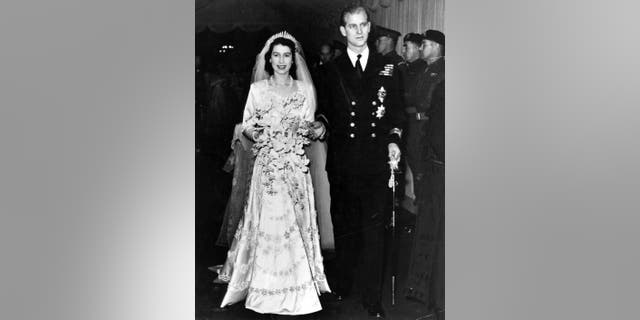 Queen Elizabeth II, as Princess Elizabeth, and her husband the Duke of Edinburgh, styled Prince Philip in 1947, on their wedding day. She became queen on her father King George VI's death in 1952.
