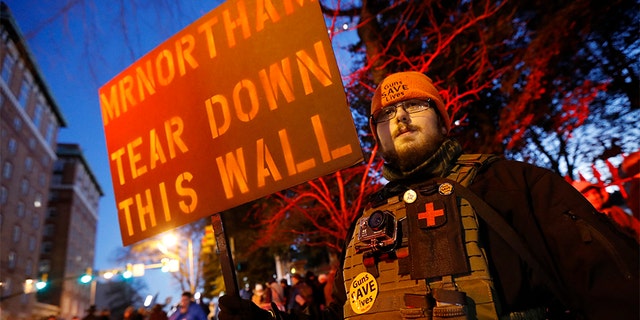 A pro-gun demonstrator holds a sign outside the Virginia Statehouse prior to a gun-rights rally in Richmond, Jan. 20, 2020. (Associated Press)