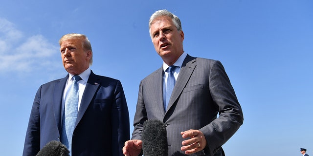 US President Donald Trump(L)speaks next to new national security advisor Robert O'Brien on September 18, 2019 at Los Angeles International Airport in Los Angeles, California. (Photo by Nicholas Kamm / AFP via Getty Images)