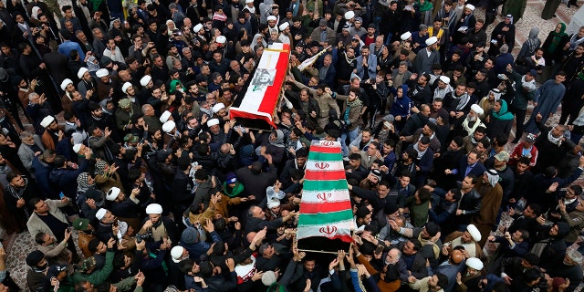 Mourners carry the coffins of Soleimani and Abu Mahdi al-Muhandis, deputy commander of Iran-backed militias, at the Imam Ali shrine in Najaf, Iraq, on Saturday. (AP Photo/Anmar Khalil)