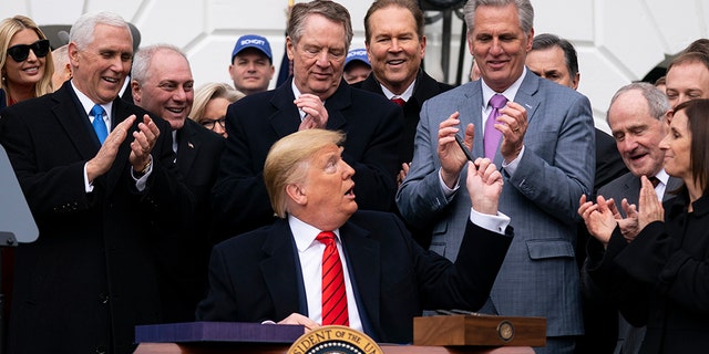 President Trump hands out pens after signing a new North American trade agreement with Canada and Mexico, during an event at the White House, Wednesday, Jan. 29, 2020, in Washington. (Associated Press)