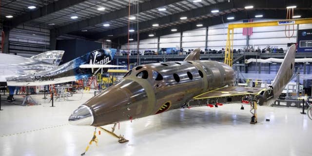 This photo released by Virgin Galactic shows the company's next passenger spaceship standing on its landing gear.