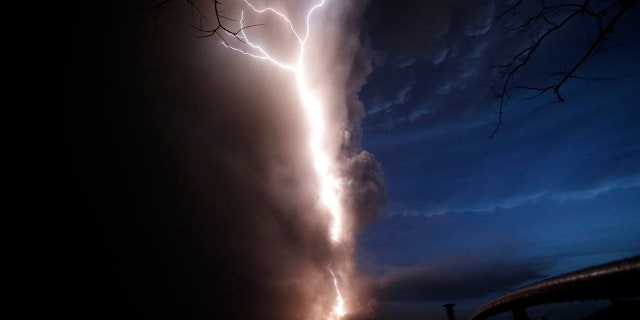 Lightning flashes as Taal Volcano erupts Sunday Jan. 12, 2020, in Tagaytay, Cavite province, outside Manila, Philippines.