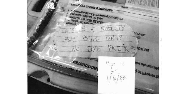 Federal prosecutors say Gerod Woodberry passed this note to a teller during a robbery that occurred after he was released under New York's bail reform law.
