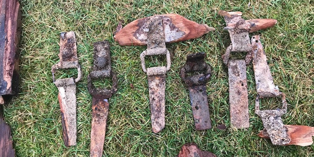 Bits of wood from the bomb crates, metal hinges and glass bottle caps from the bombs of incendiary bombs found on a beach at Loch Morlich. (Credit: SWNS)