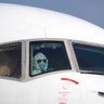 A pilot wearing a protective suit parks a cargo plane at Wuhan Tianhe International Airport in Wuhan, China, Jan. 28, 2020. 