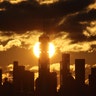 The sun rises behind the skyline of lower Manhattan and One World Trade Center in New York City, Jan. 5, 2020 