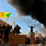 Protesters burn property in front of the U.S. embassy compound, in Baghdad, Iraq, Dec. 31, 2019. 