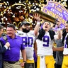 Joe Burrow of the LSU Tigers raises the National Championship Trophy with Ed Orgeron, Grant Delpit, Patrick Queen, and Rashard Lawrence after defeating the Clemson Tigers in the College Football Playoff National Championship game in New Orleans, Jan. 13, 2020.