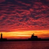 The first sunrise of 2020 brings deep orange and pink colors over the Duluth Harbor North and South Breakwater Lighthouses in Duluth, Minnesota, Jan. 1, 2020. 