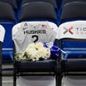 A seat with a jersey and flowers is reserved in memory of Gianna Bryant before an exhibition basketball game between the Connecticut Huskies and the US Women's National team, in Hartford, Jan. 27, 2020.