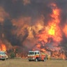 Firefighters work to protect homes around Charmhaven, New South Wales, Dec. 30, 2019.