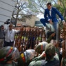 National Assembly President Juan Guaido, Venezuela's opposition leader, climbs the fence in a failed attempt to enter the compound of the Assembly, as he and other opposition lawmakers are blocked from entering a session to elect new Assembly leadership in Caracas, Venezuela, Jan. 5, 2020. 