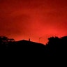 A red glow in the sky above homes from wildfires burning, in Victoria, Australia., Dec. 31, 2019.