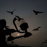 A Hindu priest performs rituals at the Sangam, the confluence of rivers Ganges and Yamuna, on Basant Panchami day at the annual traditional fair of Magh Mela Prayagraj, India, Jan. 30, 2020. 