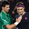 Serbia's Novak Djokovic consoles Switzerland's Roger Federer after winning their semifinal match at the Australian Open tennis championship in Melbourne, Australia, Jan. 30, 2020.