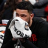 Houston Rockets guard Austin Rivers sits on the bench after learning of Bryant's death.