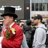 Gregg Donovan, AKA The Hollywood Ambassador, carries flowers at a gathering for Kobe Bryant near Staples Center in Los Angeles.