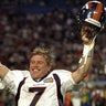 Jan. 31, 1999, Miami: Quarterback John Elway #7 raises his hands in victory after he is pulled from the game in the final seconds of the Denver Broncos Super Bowl XXXIII victory over the Atlanta Falcons 34-19 at Pro Player Stadium. This would be John Elway's last football game of his career.
