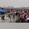 People standing in line to get into the rally.