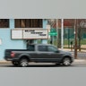 A pickup truck passing a sign welcoming President Trump in Wildwood, N.J.