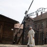 Pope Francis walks through a gate with the words "Arbeit macht frei" ("Work sets you free") at the former Nazi German concentration and extermination camp Auschwitz-Birkenau in Oswiecim, Poland, July 29, 2016.