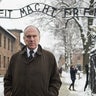 Then-president of the World Jewish Congress Ronald Lauder stands near the lettering "Arbeit macht frei" ("Work sets you free") hanging at the entrance gate of the former Auschwitz concentration camp held by the Nazis during WWII in Oswiecim on Jan. 26, 2015. 