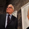 Holocaust survivor Naftali Furst stands next to his portrait during the opening of the exhibition 'Survivors - Faces of Life after the Holocaust' at the former coal mine Zollverein in Essen, Germany, on Jan. 21, 2020. 
