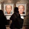 Visitors look at portrait photos of the exhibition "Survivors - Faces of Life after the Holocaust" at the former coal mine Zollverein in Essen, Germany, on Jan. 21, 2020. 