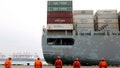 In this Tuesday, Feb. 4, 2020, photo, workers watch a container ship arrive at a port in Qingdao in east China's Shandong province. China cut tariffs on $75 billion of U.S. imports including auto parts on Thursday, Feb. 6 in response to American reductions as part of their truce in a trade war. (Chinatopix via AP) - Fox News