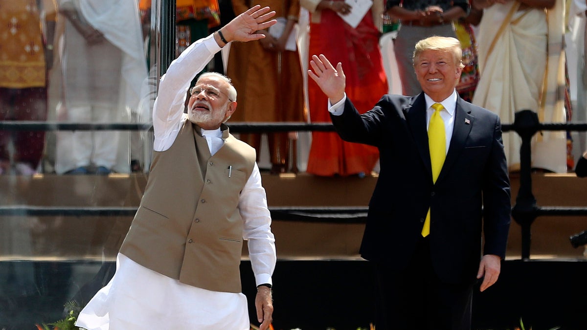 U.S. President Donald Trump and Indian Prime Minister Narendra Modi wave to the crowd at Sardar Patel Stadium in Ahmedabad, India, Monday, Feb. 24, 2020. (AP Photo/Aijaz Rahi)