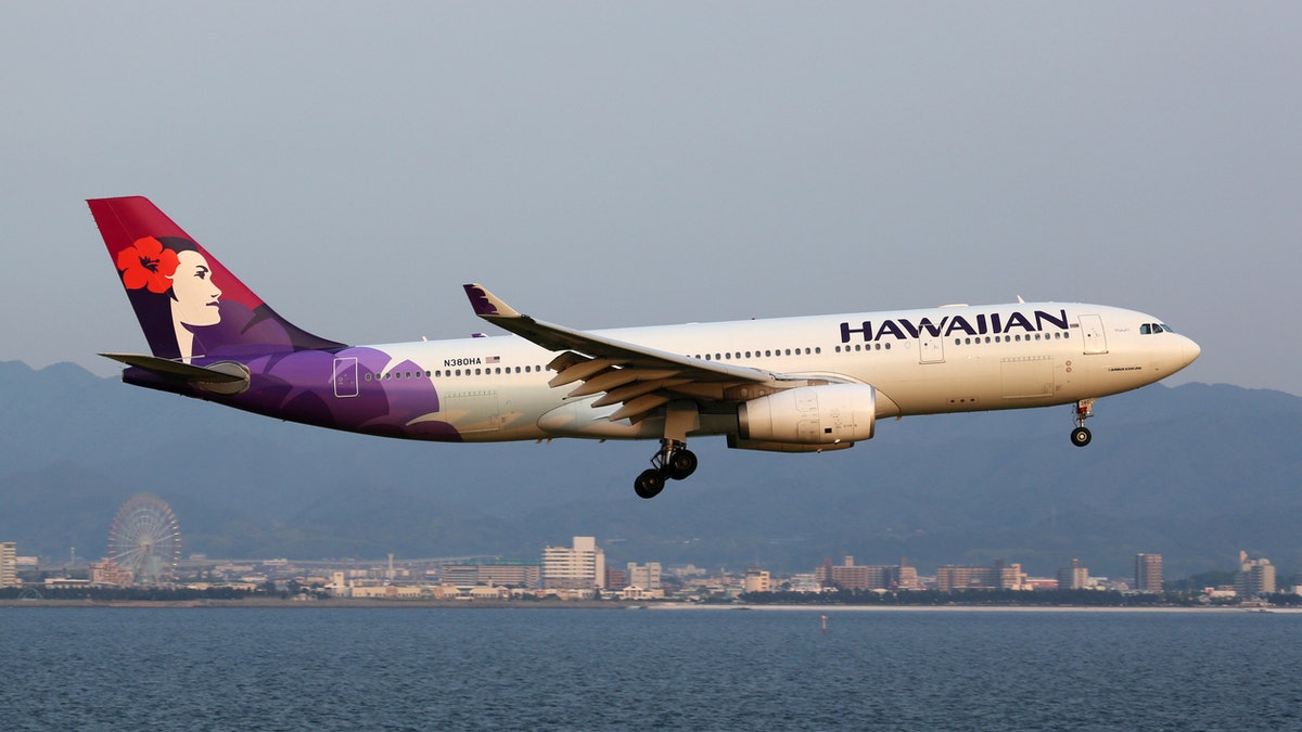 Osaka Kansai, Japan - May 24, 2014: A Hawaiian Airlines Airbus A330-200 with the registration N380HA approaching Osaka Kansai Airport (KIX) in Japan. Hawaiian Airlines is a US airline based in Honolulu, Hawaii.