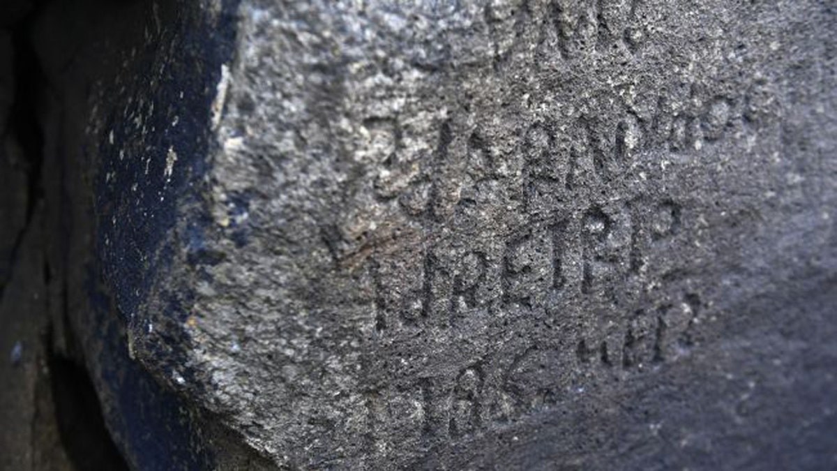 A mysterious inscription engraved centuries ago on a rock at a French beach was finally unscrambled, thanks to an international competition launched in 2019. (Credit: Fred Tanneau/AFP via Getty Images)