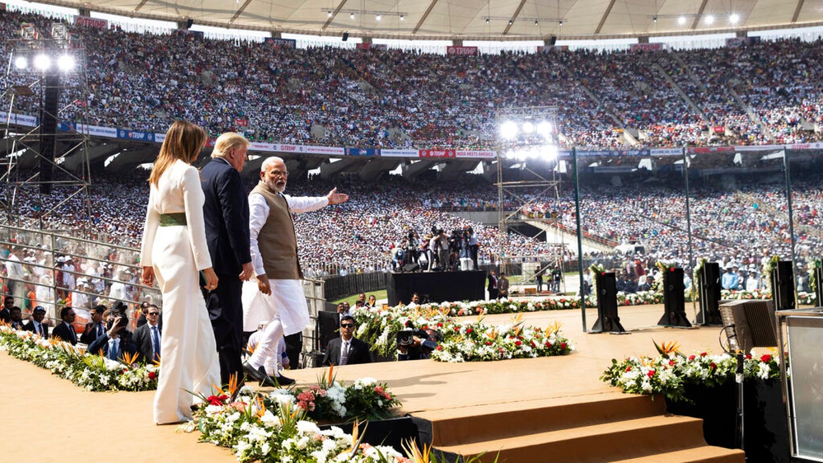 U.S. President Donald Trump, first lady Melania Trump, and Indian Prime Minister Narendra Modi arrive for a "Namaste Trump," event at Sardar Patel Stadium. (AP Photo/Alex Brandon)