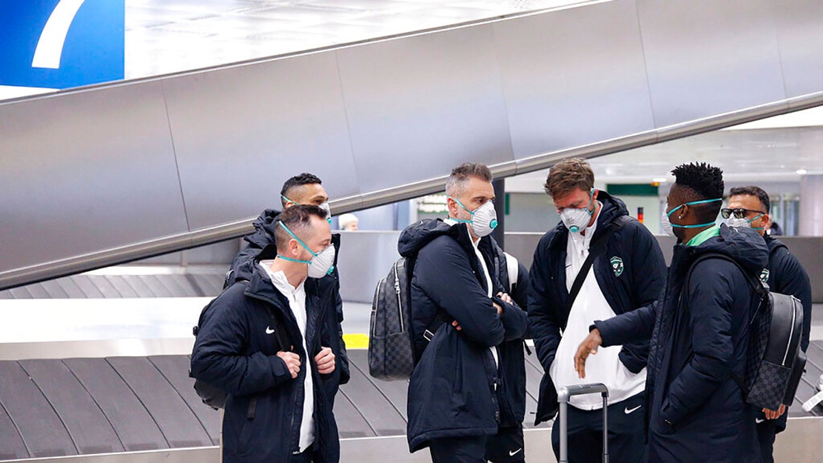 Members of Bulgarian soccer team Ludogorets are seen wearing protective face masks at Malpensa airport in Milan, Italy, ahead of their Europa League soccer match on Feb. 27.