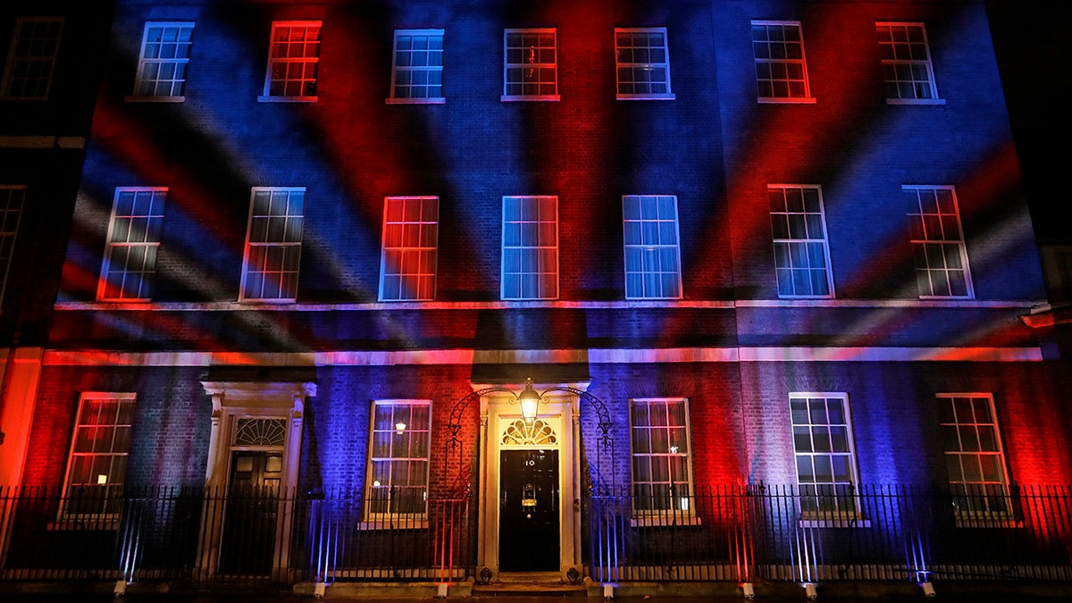 The colors of the British Union flag illuminate the exterior of 10 Downing street, the residence of the British Prime Minister, in London, England, Friday, Jan. 31, 2020. Britain officially left the European Union on Friday after a debilitating political period that has bitterly divided the nation since the 2016 Brexit referendum. (AP Photo/Kirsty Wigglesworth)