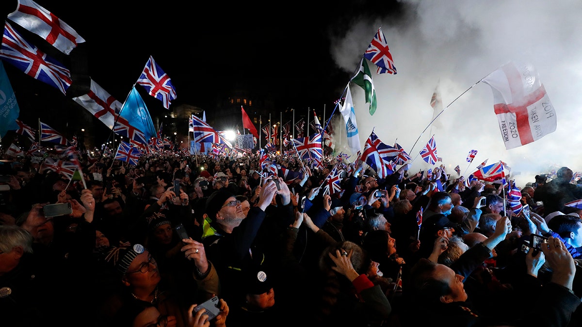 Brexit supporters celebrate during a rally in London, Friday, Jan. 31, 2020. Britain leaves the European Union after 47 years, leaping into an unknown future in historic blow to the bloc. (AP Photo/Frank Augstein)