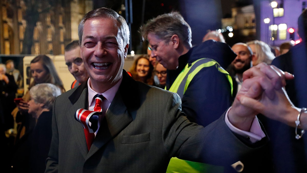 Brexit Party leader Nigel Farage shakes hands with his supporters in London, Friday, Jan. 31, 2020. The U.K. is scheduled to leave the EU at 23:00 GMT Friday, the first nation in the bloc to do so. (AP Photo/Frank Augstein)